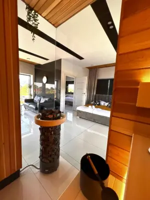 a wooden sauna with a pool in the middle at Apartament 106 in Andrychów