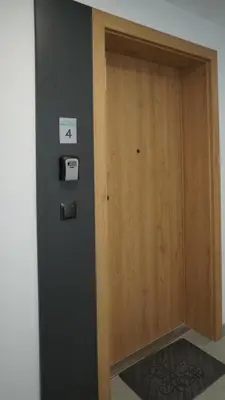 a wooden door with a sign on a wall at Castle Apartments - Queen in Oświęcim