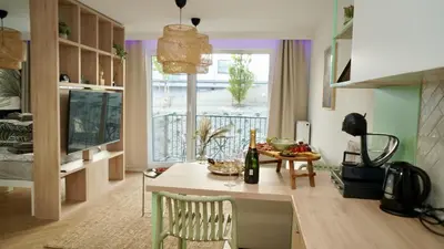 a kitchen with a table and a dining room at Castle Apartments - Queen in Oświęcim