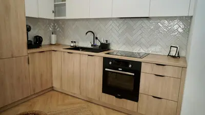a kitchen with a sink and a stove top oven at Castle Apartments - King in Oświęcim