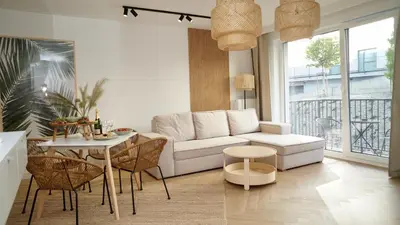 a living room with a white couch and a table at Castle Apartments - King in Oświęcim