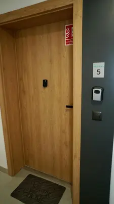 a wooden door in a room with a sign on it at Castle Apartments - King in Oświęcim
