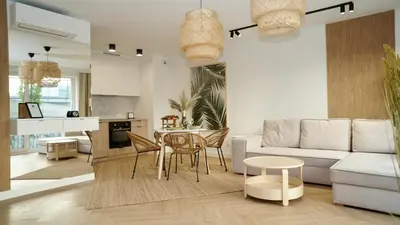 a living room with a white couch and a table at Castle Apartments - King in Oświęcim