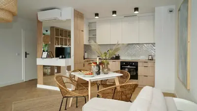 a kitchen and living room with a table and chairs at Castle Apartments - King in Oświęcim
