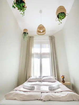 a bed in a bedroom with a window at Bed & Beige Apartment / Kochanowskiego St in Kraków