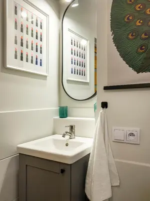 a bathroom with a sink and a mirror at Bed & Beige Apartment / Kochanowskiego St in Kraków