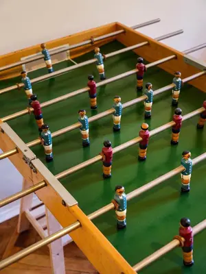 a group of toy people playing a game of billiard at Bed & Beige Apartment / Kochanowskiego St in Kraków