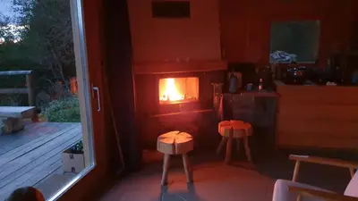 a kitchen with a fire in a stove in a room at Domek w drapie in Lubomierz