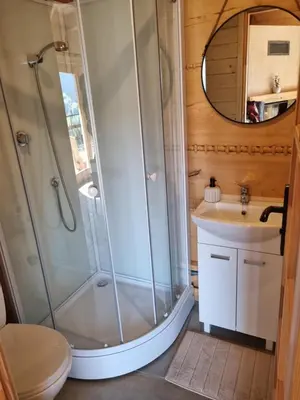 a bathroom with a shower and a sink at Domek w drapie in Lubomierz