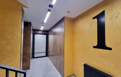 a hallway with a large number one on the wall at No 7 Terrace in Kraków
