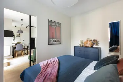 a bedroom with a blue bed and a desk at No 7 Terrace in Kraków