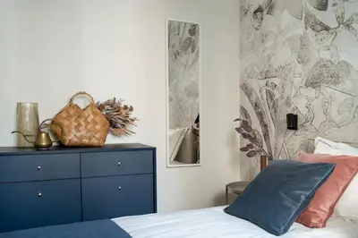 a bedroom with a blue dresser and a bed at No 7 Terrace in Kraków