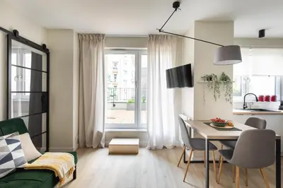 a living room with a table and a dining room at No 7 Terrace in Kraków