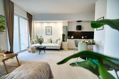 a living room with a white couch and a table at Zator Apartament MINT wanna spa in Zator