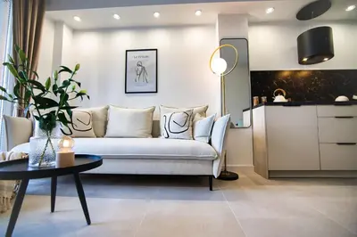 a living room with a couch and a table at Zator Apartament MINT wanna spa in Zator
