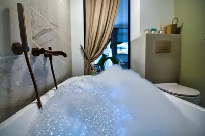 a tub filled with a lot of water at Zator Apartament MINT wanna spa in Zator