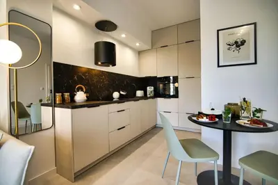 a kitchen with a table and chairs in a room at Zator Apartament MINT wanna spa in Zator