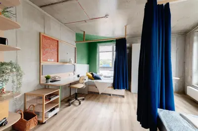 an office with a blue curtain in a room at Chillout Dorm Cracow by BookingHost in Kraków