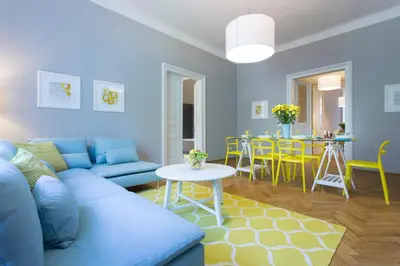 a living room with a blue couch and a table at Tyzenhauz Grand Apartaments in Kraków