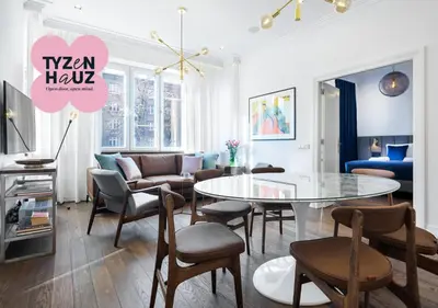 a living room with a table and chairs at Tyzenhauz Grand Apartaments in Kraków