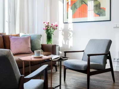 a living room with a couch and chairs and a table at Tyzenhauz Grand Apartaments in Kraków