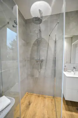 a bathroom with a shower and a sink at Comfort Apartments Oświęcim in Oświęcim