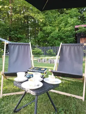 two chairs and a table with plates of food on it at Małopolskie Swojskie in Olszyny