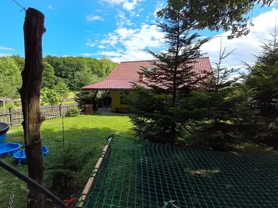 a fence in a yard with a house at Małopolskie Swojskie in Olszyny