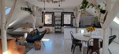 a kitchen and living room with a table and chairs at Małopolskie Swojskie in Olszyny