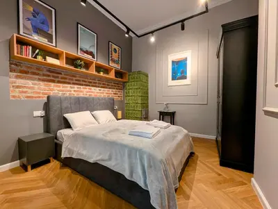 a bedroom with a bed and a brick wall at Bonerowska 5 by Homeprime in Kraków