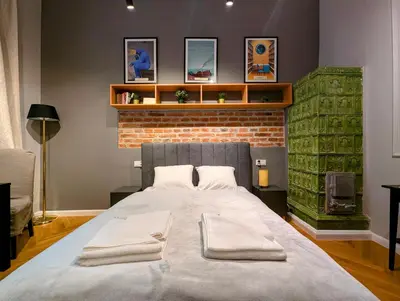 a large bed in a room with a brick wall at Bonerowska 5 by Homeprime in Kraków