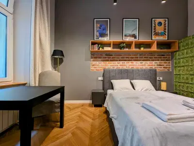 a bedroom with a bed and a desk in it at Bonerowska 5 by Homeprime in Kraków