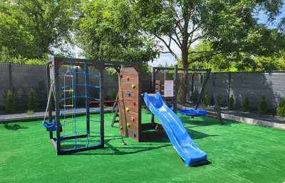 a playground with a slide and a climbing frame at Lipowy Zakątek - domki blisko Energylandii i stacji PKP w Zatorze in Zator