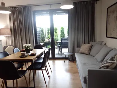 a living room with a couch and a table at Lipowy Zakątek - domki blisko Energylandii i stacji PKP w Zatorze in Zator