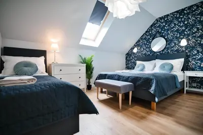 a bedroom with a large bed and a mirror at Lipowy Zakątek - domki blisko Energylandii i stacji PKP w Zatorze in Zator