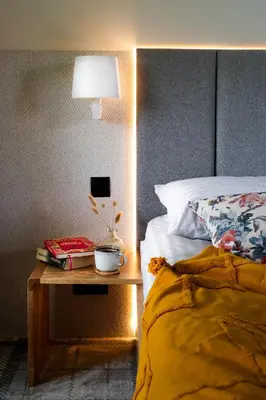 a bedroom with a bed and a table with a lamp at Kurka Chata in Nowy Targ
