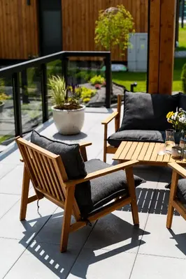 a patio with two lounge chairs and a table at Kurka Chata in Nowy Targ