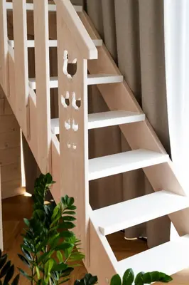 a wooden book shelf in a stair case at Kurka Chata in Nowy Targ