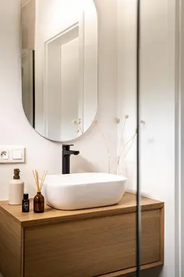 a bathroom with a sink and a mirror at Babia Rest - całoroczny domek z balią z jacuzzi in Zawoja