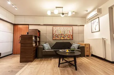 a living room with a couch and a table at Apartament G76 free parking in Kraków