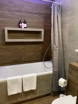 a large kitchen with a table and a chair at Apartament G76 free parking in Kraków