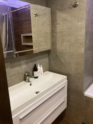 a blue room with a bed with towels on it at Apartament G76 free parking in Kraków