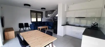 a bedroom with a bed and a desk and a window at Panorama Beskidu in Skrzydlna