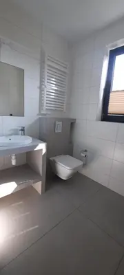 a kitchen with white cabinets and a clock on the wall at Panorama Beskidu in Skrzydlna
