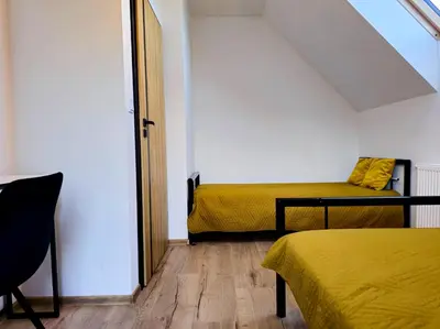 a small room with two beds and a window at Panorama Beskidu in Skrzydlna