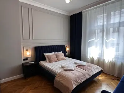 a bedroom with a large bed with a window at Premium Apartment in Spiski Palace in Kraków