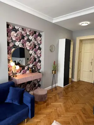 a living room with a blue couch and a mirror at Premium Apartment in Spiski Palace in Kraków