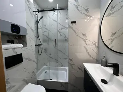 a bathroom with a shower and a toilet and a sink at Premium Apartment in Spiski Palace in Kraków