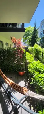 a bench with a potted plant on a patio at Luxury Apartments, self check in 24 h & Free Parking in Kraków