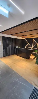 a room with a table and a wooden floor at Luxury Apartments, self check in 24 h & Free Parking in Kraków